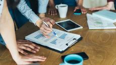 Businesspeople looking at financial results charts. 