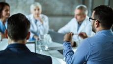 Business persons sitting around a table