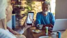 An older couple talking to a doctor via telehealth