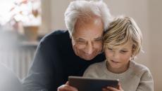 An adult and a child using a tablet together