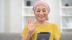 Person waving at tablet