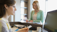 Receptionist taking patient's insurance