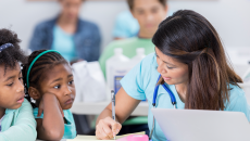 Nurse talking to children